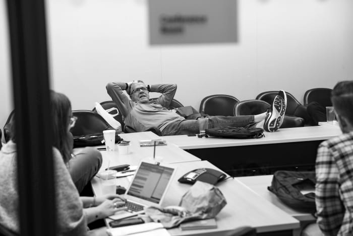 Peter King puts his feet up on the table and leans back in a chair